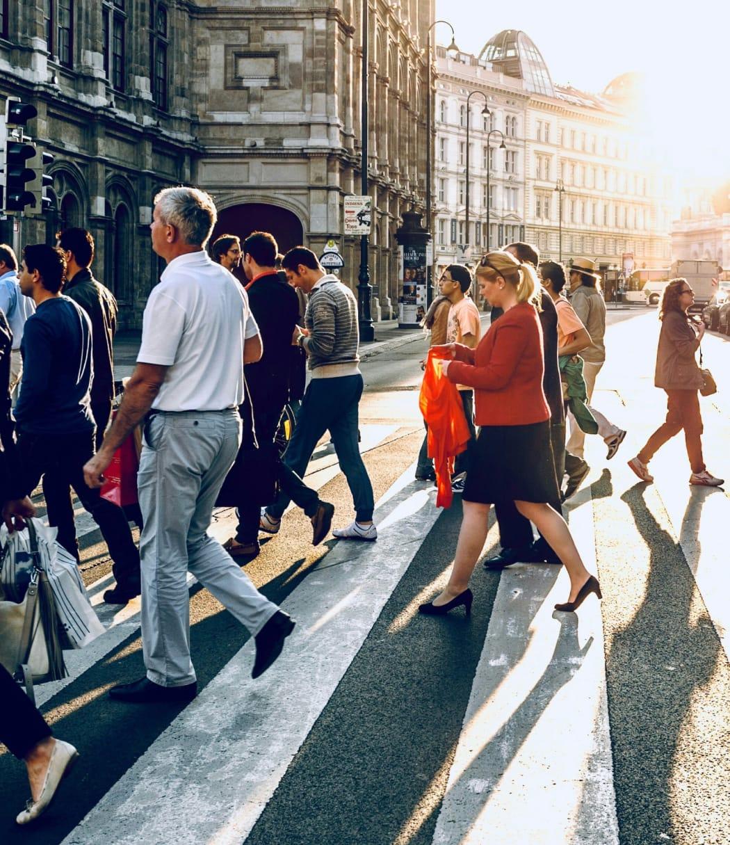 People walking across a zebra crossing in a city location